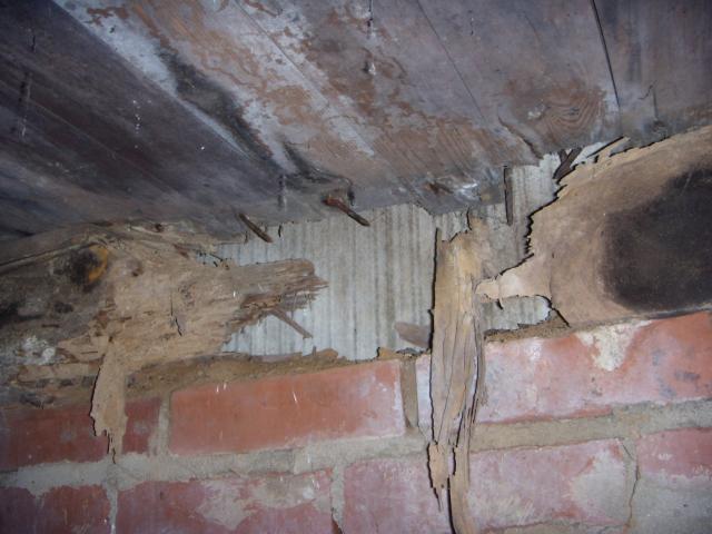 Wooden sill rotted away and bedroom floor is collapsing